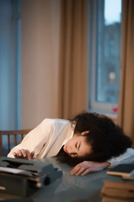 Exhausted woman resting her head on the table